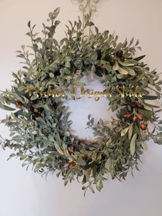 an olive wreath hangs on the wall