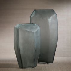 two vases sitting next to each other on a table