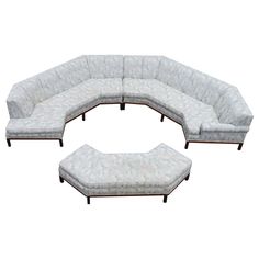 a large sectional couch with matching footstools