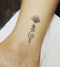 a woman's foot with a flower tattoo on the left side of her ankle