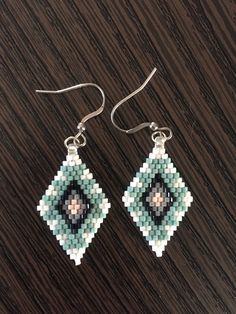 These earrings are made with matte green, white and gray seed beads with shiny pink and black accents. Colors are the most accurate in the first picture. The findings are stainless steel fishhooks. Beaded Cross Earrings, Native Earrings, Earrings Patterns, Matte Green, Beaded Cross, Beaded Earrings Patterns, Beadwork Patterns, Cross Earrings, Southwestern Style