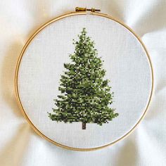 a cross stitch christmas tree on a white background