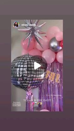 balloons and streamers are arranged in the shape of a disco ball with a star on top