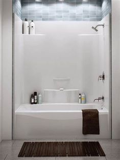 a white bath tub sitting next to a shower