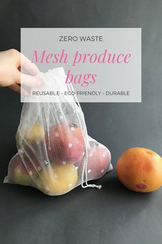 a hand holding a mesh produce bag next to an orange on a black surface with the text zero waste mesh produce bags reusable eco - friendly - friendly