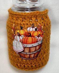 a crocheted jar with pumpkins on it