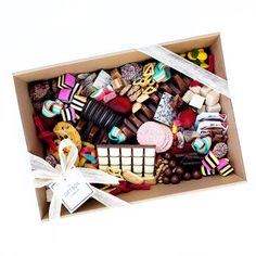 a box filled with lots of different types of cookies and candies on top of each other