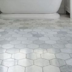 a white bath tub sitting inside of a bathroom