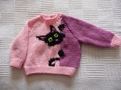 a pink sweater with a black cat on it