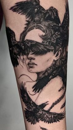 a woman's arm with a black bird on it