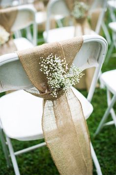 the chairs are decorated with burlocks and baby's breath