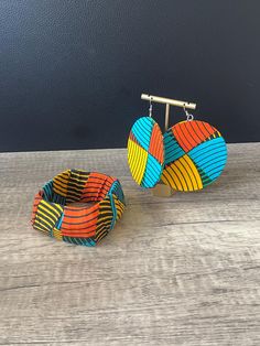 African Print Jewellery Set Sold as separates Features - Ankara Circle Earrings - Ankara Bangle Primary Colours: - Multi You can find out more about our brand at: https://www.naborhi.com You can follow us on: https://www.instagram.com/naborhi.africa/ https://facebook.com/naborhi Thank you for visiting our shop! Temisan If you have any questions about any of our items please give me  a shout Check out our shop for more African Inspired Fashion and Accessories: https://www.etsy.com/uk/shop/Naborhi Adjustable Round Multicolor Jewelry Sets, Adjustable Multicolor Jewelry Sets For Gifts, Adjustable Multicolor Round Earrings, Ankara Jewelry, African Bangles, Ankara Earrings, Primary Colours, African Inspired Fashion, Printed Jewelry