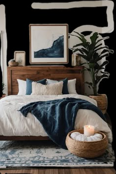 a bedroom with a bed, plant and pictures on the wall