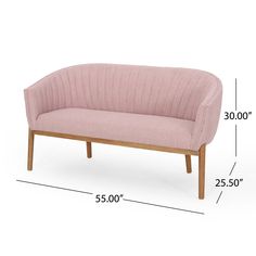 a pink couch sitting on top of a white floor next to a wooden frame with measurements