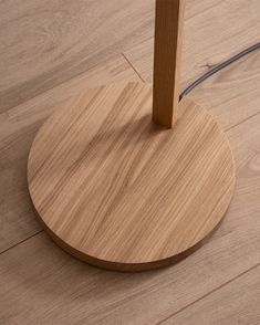 a wooden floor with a light on top of it and a cord running through the middle