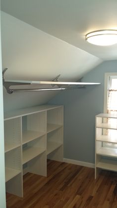 an empty room with white shelves and shelving