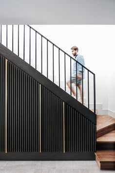 a man standing on top of a stair case next to a set of wooden steps