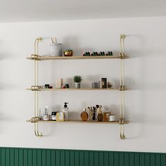 three shelves with various items on them against a white wall in a green and white room