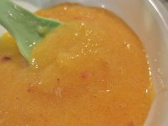 a close up of a bowl of food with a green leaf on the top of it