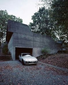 an old car is parked in front of a building with stairs leading up to it