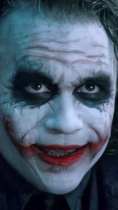 a close up of a person with makeup on and his face painted to look like the joker