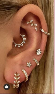 an ear with three different types of piercings on it