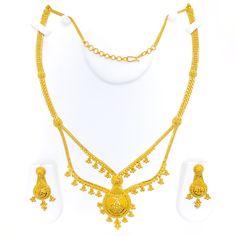 This 22k gold long necklace set features an ornamental tasseled drop design, perfect for adding elegance to any outfit. Weighing 53.9 grams, it showcases a yellow gold finish that enhances its intricate and eye-catching appearance. The set has a length of 24 inches with a 2.25-inch drop and includes adjustable 1.5-inch links for a comfortable fit. Secured with a hook lock, it combines style and practicality. The matching earrings, each 1.75 inches long, feature screw back posts for added security. Ideal for those who appreciate luxurious and sophisticated jewelry, this set brings a touch of opulence and tasseled charm to your collection. PRODUCT DETAILS Gold Purity(karat): 22k Gold Weight(grams): 53.9 Item Finish: Yellow Gold Set Length: 24" Drop Length: 2.25" Adjustable Links: 1.5" Links Luxury Long Gold Sets, Luxury Yellow Gold Danglers For Diwali, Luxury 22k Gold Jewelry Sets, Gold Long Necklace Set, Long Necklace Set, Bridal Jewelry Necklace, Precious Stones Rings, Sophisticated Jewelry, Diamond Pendant Sets