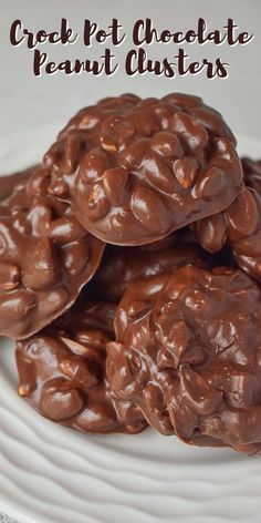 chocolate peanut clusters on a white plate with text overlay that reads crock pot chocolate peanut clusters