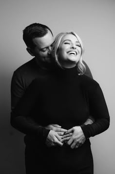 black and white photograph of a couple embracing each other with their hands on their chest