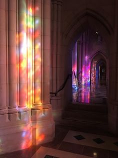 the light is shining through the stained glass windows in this building's interior area