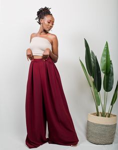 The TULIPS Palazzo pants can easily transition from an office look to a casual look depending on how you style them. Pair them up with a pair of heels & a blazer to achieve an official look. Transition to a casual look by throwing in a bandeau top and sneakers/ sandals. Made from polyester fabric. The pants measure 47 inches/ 119 cm from the waist. The model is wearing a UK 6/ XS. She is 5'6 / 171cm tall. The pants have pockets on both sides. Colour: Dark Maroon * Made in Kenya with 🧡 SIZE GUID Casual Business Wide-leg Pantsuit, Chic Tailored Bottoms For Day Out, Elegant Wide Leg Pants For Fall Day Out, Casual High Waist Business Casual Pantsuit, Chic Ankle-length Dress Pants For Day Out, Casual Straight Pantsuit For Night Out, Casual High-waisted Pantsuit For Night Out, Mode Queer, Layering Outfits Fall