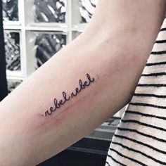 a person with a tattoo on their arm that reads, reeblikke in cursive writing