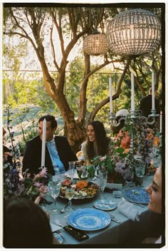 a group of people sitting around a dinner table