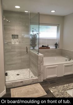 a bathroom with a walk in shower next to a bath tub and sink counter top