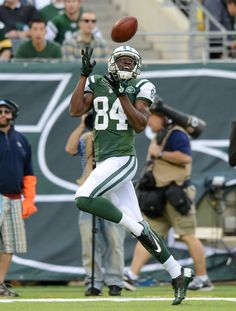 a football player catching a ball in the air