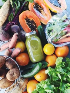 an assortment of fruits and vegetables sitting on top of a table next to each other