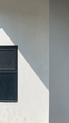 a white building with a black door and window