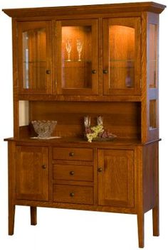 a wooden hutch with glass doors and drawers on it's front door,