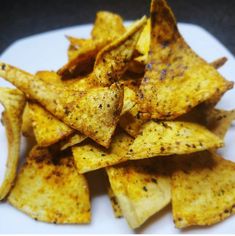 a white plate topped with chips on top of a table