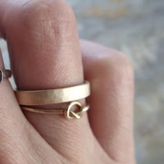 a woman's hand with a gold ring on it