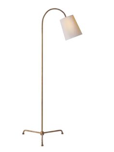 a floor lamp with a white shade on it