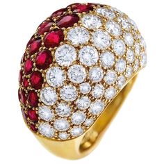 Leave it to Cartier to create the perfect bombe style ring. A ruby and diamond ring by CARTIER Of bombé design, one side pavé-set with diamonds, the other pavé-set with rubies, with French assay mark for gold Signed Cartier. The image shows a luxurious Cartier ring with a striking and bold design. The ring has an oval, dome-like shape, which is fully encrusted with an intricate pavé setting of two types of gemstones. One half of the ring features vibrant, deep red rubies, while the other half is adorned with sparkling, white diamonds. The gemstones are meticulously set, creating a seamless transition between the two colors, giving the ring a distinctive and sophisticated look. The ring's band, although not fully visible, appears to be made of yellow gold, which enhances the richness of the Luxury Domed Red Jewelry, Luxury Red Domed Jewelry, Luxury Domed Ruby Ring, Luxury Red Dome Ring For Anniversary, Luxury Red Dome Ring For Formal Occasions, Jeanne Toussaint, Pink Diamonds Engagement, Rubies And Diamonds, Ruby Diamond Rings