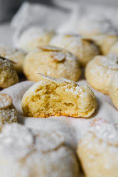 some powdered sugar cookies are on a white cloth