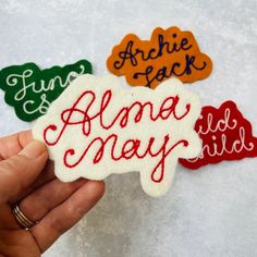 someone is holding up some handmade magnets with the words alme may on them