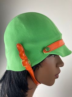 Fabulous pea green helmet swim cap with orange chin and visor strap. Great mod styling for a great Carnaby Street/That Girl look.  Outside fabric feels to be a stretch nylon, which is bonded to an inner latex/rubber/plastic layer (not sure which). Cap is in very good to excellent condition, with some cracking in the underlayer and a small pull or on the outside. Fitted Retro Green Hat, Retro Fitted Green Hat, Green Fitted Retro Hat, That Girl, Cap Outfit, Crochet Swim, Louis Feraud, Swim Cap, Carnaby Street