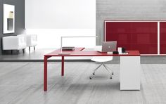 a red and white desk with a laptop on it