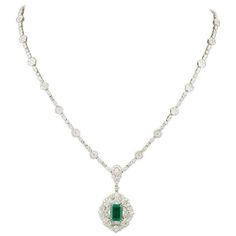 About A stunning green emerald and diamond necklace in a classic design. 1.84 carat GIA certified emerald cut Green Emerald. The emerald is surrounded by diamonds and hangs from a diamond necklace featuring 9.40 carats of diamonds F-G in... Emerald And Diamond Necklace, White Gold Pendant Necklace, White Gold Pendant, Green Emerald, Emerald Diamond, Gold Pendant Necklace, Emerald Cut, Diamond White, Gold Pendant