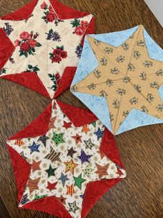 three quilted stars on a wooden table