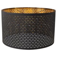 a black and gold lamp shade with circles on the bottom, hanging from a ceiling fixture