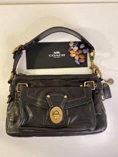 COACH Legacy Shoulder Bag Strap Black Vachetta Leather: Zip Turn-Lock Tote 11127 100% Authentic: Please purchase in confident. Good Condition ; Few stains inside (as Photos) ; Zip closure ; Outer Pocket with Turn-Lock ; Shoulder Bag / Hand bag / Tote MSRP: $498 Leather & Canvas Inside zipper pocket, dividers,  fabric lining Zip closure Shoulder Strap included (Shoulder Bag / Tote) Dimension : 11.5" (W) x 7" (H) x 3.5" (D) Style No. E0769-11127 IN SMOKE AND PET FREE HOME! About Color: Please unde Cute Shoulder Bags, Unique Bags Design, Coach Vintage Handbags, Uni Bag, Luxury Tote Bags, Best Tote Bags, Coach Legacy, Hippie Bags